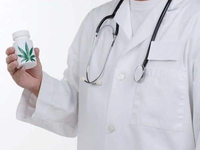 Profesional sanitario con bata blanca sosteniendo un envase con hoja de cannabis